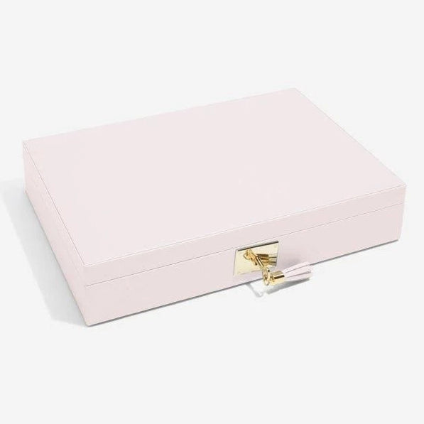Stackers Leather Jewellery Box 75449 Blossom Pink Leather Lidded. This beautifully luxurious leather jewellery box is ideal for housing your jewellery collection, from necklaces and bracelets to rings and earrings. This lid includes a fitted ring roll and 12 storage sections, with a wide, primary section perfect for keeping necklaces tangle-free. Complete with an interior mirror and finished with gold detailing as well as a lock with leather tasseled key, to keep your sentimental items safe and secure.